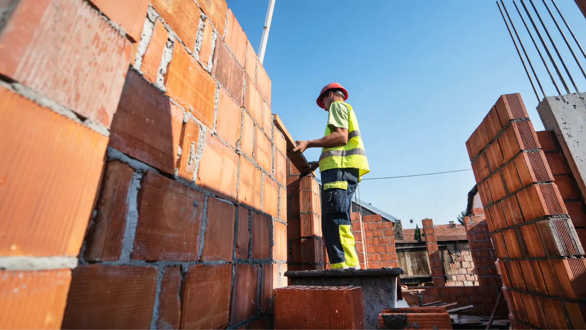 Worker working on building a wall using bricks